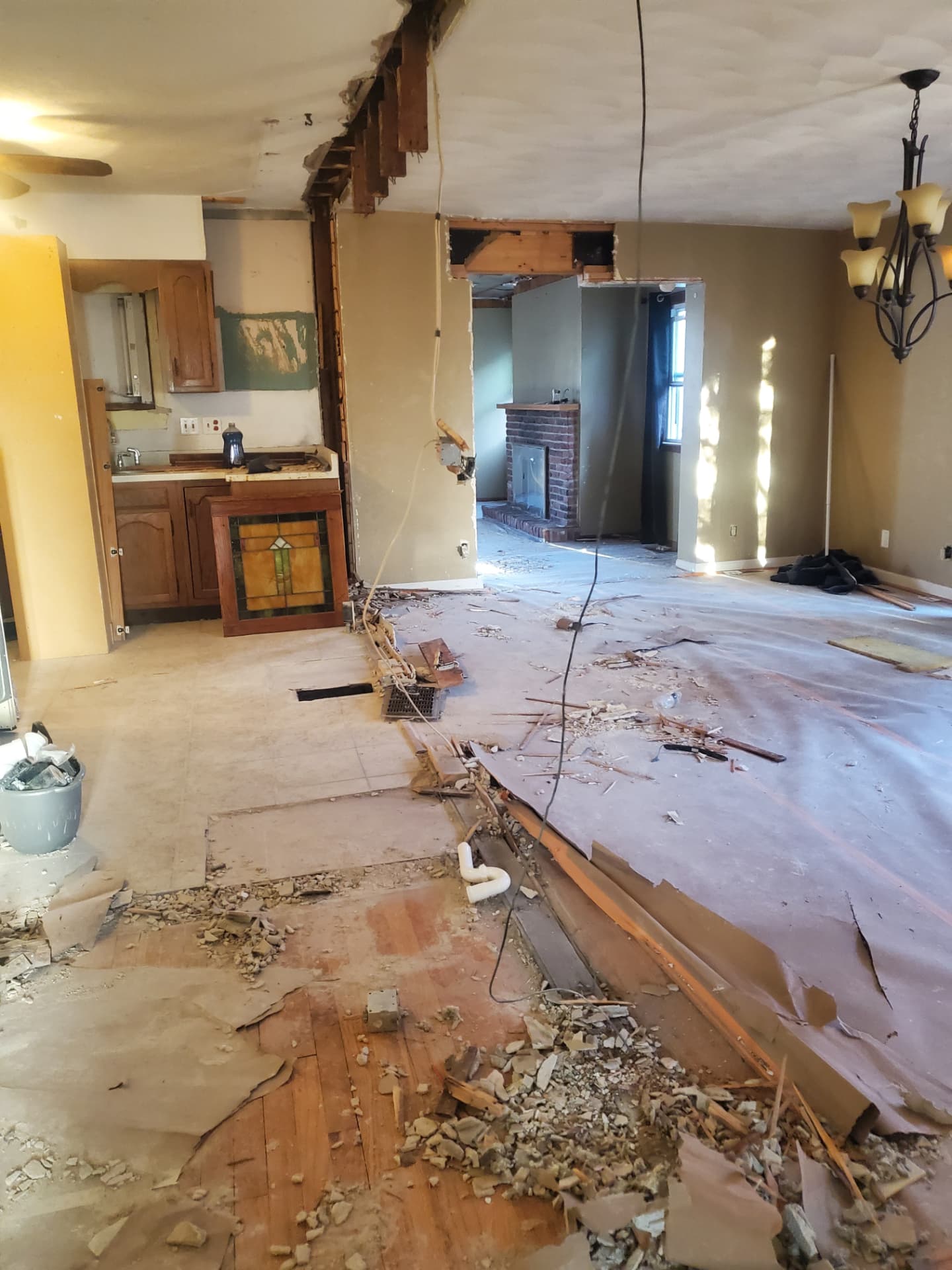 Main living space opened up toward the fireplace during demolition