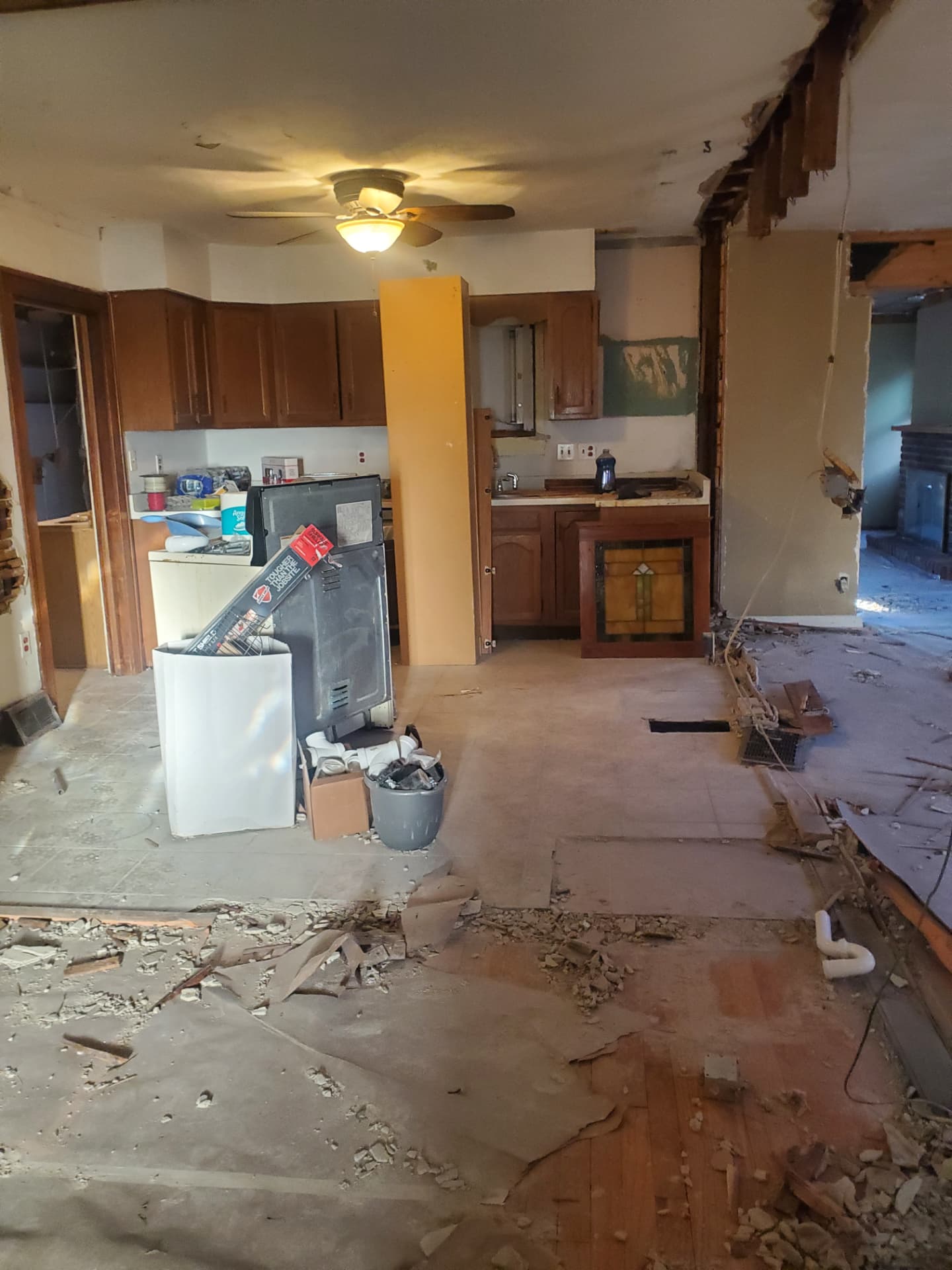 Open kitchen and living area with plaster and flooring removed