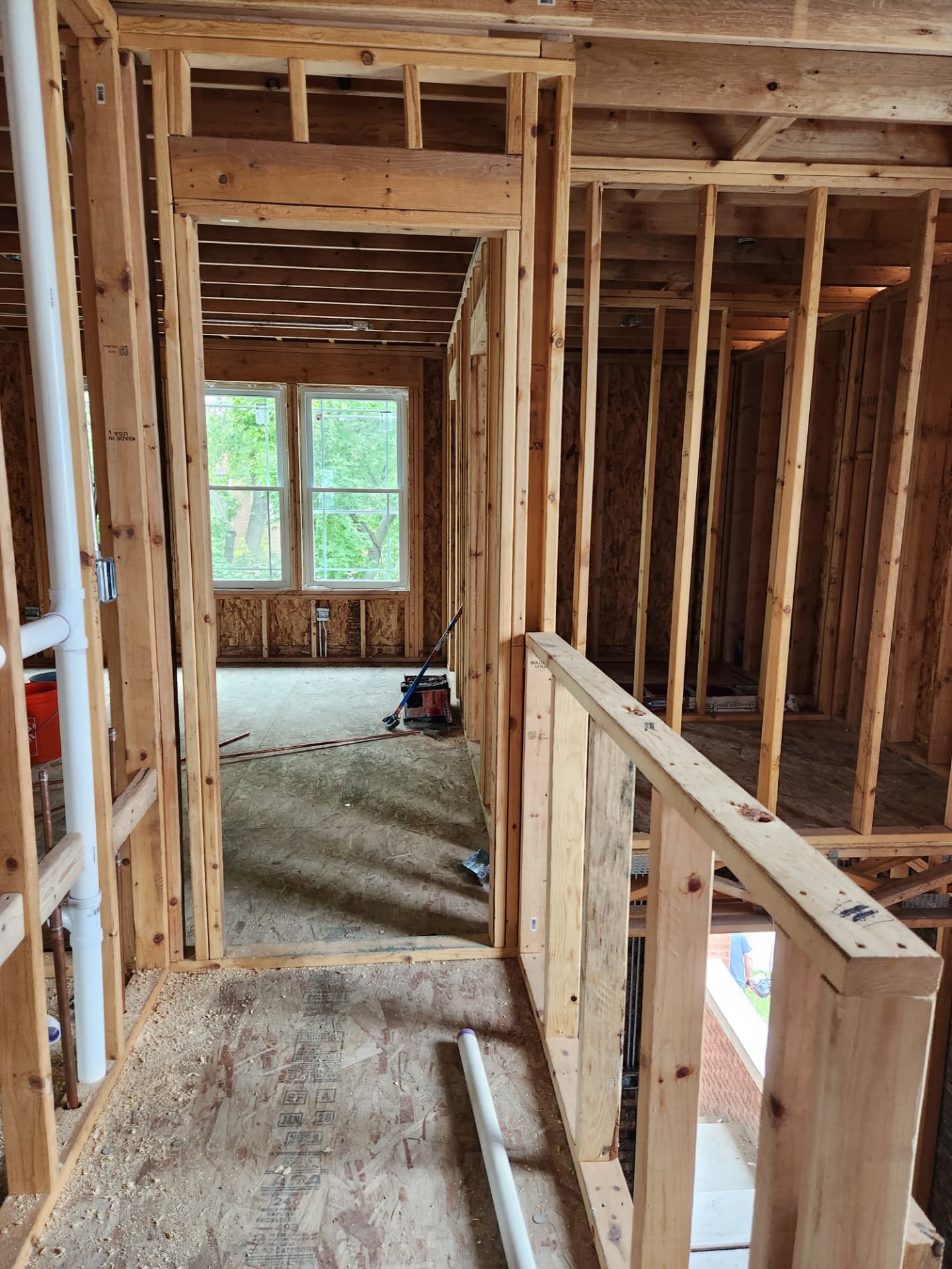 Framed upper-level rooms and hallway during construction