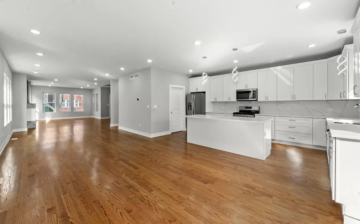 Finished open-concept kitchen and living area with hardwood floors